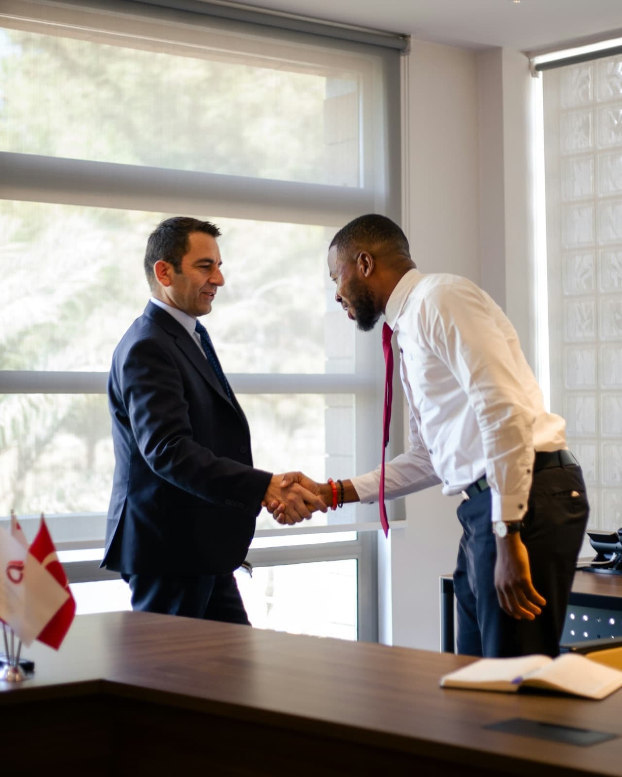 Two business people shaking hands after agreeing to restructure borrowing
